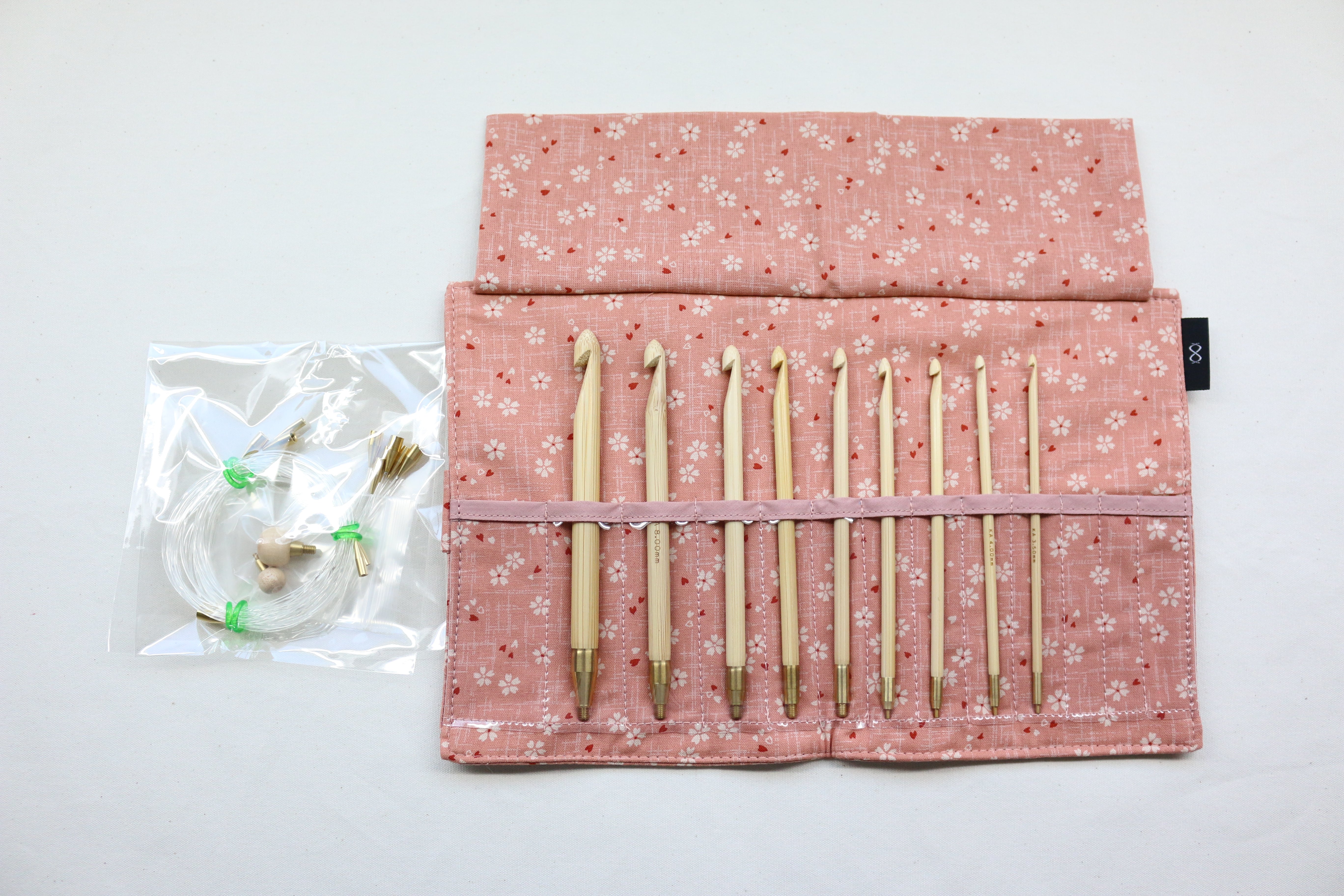 https://needles-and-wool.com/cdn/shop/products/57837-03_Interchangeable_Crochet_Hook_Set_9_sizes_EU_Nordic_-_Cherry_Blossom_Pink_Inside_with_Cords_Stppers.jpg?v=1577994116